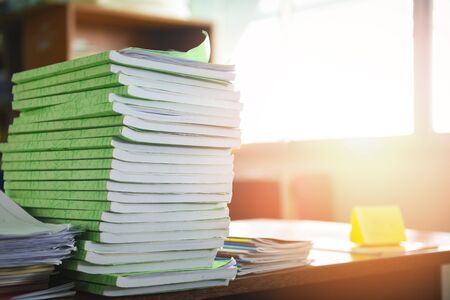 Lot of work document file working and book stacks of paper files searching information on work desk...