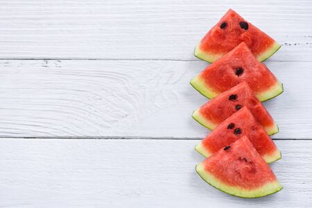 Fresh watermelon slice on white wooden background / watermelon tropical fruit on top view copy space