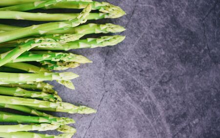 Fresh asparagus on black background / Bunch green Asparagus organic for cooking food , top view copy spaceの写真素材