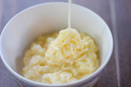 Pour the sauce mayonnaise in white bowlの写真素材