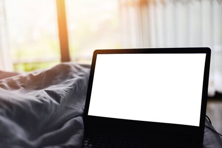 relaxing in the hotel room and working labtop on the bed and nature sunrise window view bedroom / blank screen labtopの写真素材