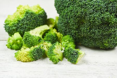 Slice Broccoli on white wooden Background / Vegetable healthy green organic raw broccoli florets ready for cooking foodの写真素材