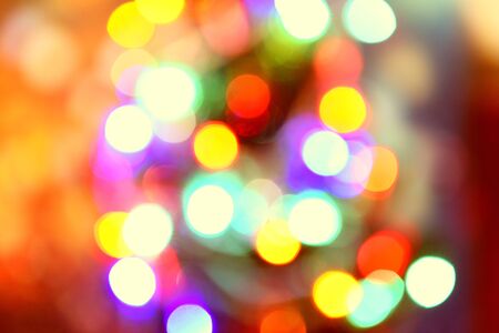 Blurred colorful bokeh and lights decorated christmas tree on black background for holidays festival...