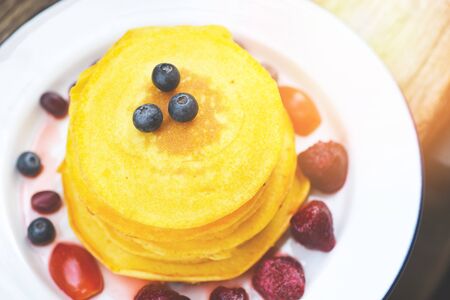 Pancake breakfast homemade healthy food / pancake fruit salad with sweet sauce on plate , top view