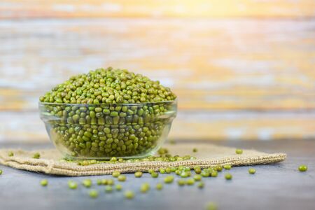 Green mung beans in bowl on the sack / Mung bean seed cereal whole grains