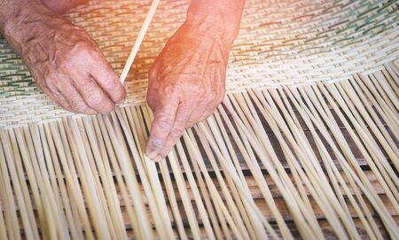 Weaving bamboo basket wooden / Old senior man hand working crafts hand made basket for nature product in Asianの写真素材