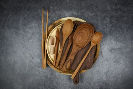 Natural kitchen tools wood products, Kitchen utensils background with spoon fork chopsticks plate cutting board object, top view on the table utensil wooden conceptの写真素材