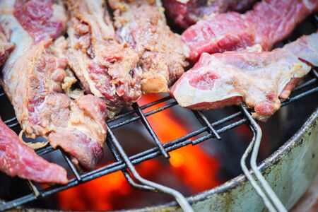 Roast beef sliced meat steaks on the grill with flames Grilled beef barbecue at street food Thailand...