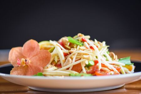 Close up of green papaya salad spicy thai food on the table selective focus - Som tum Thai Asian...