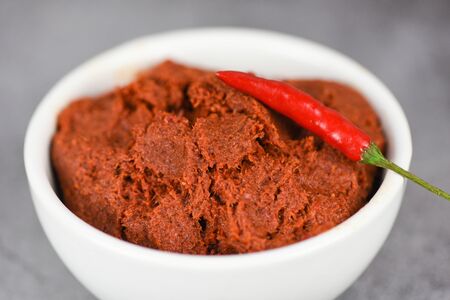 curry paste and red chilli peppers background / ingredients table asian food spicy in thailandの写真素材