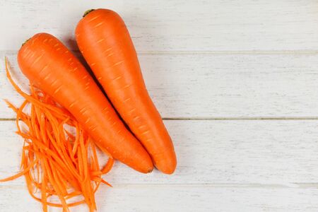 carrot slice / fresh shredded carrots on wood table , top viewの写真素材