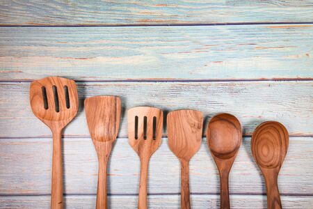 Natural kitchen tools wood products / Kitchen utensils background with spoon ladle spatula various...