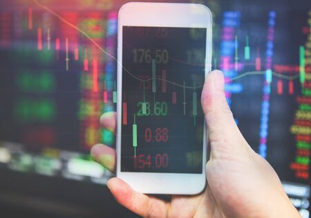 trade war world economy is down stock crisis market red price drop down chart fall business and finance crash money losing moving use smartphone trading online analysis investment economic の写真素材