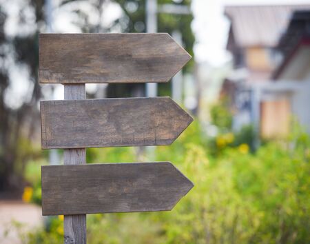 Crossroad signpost arrow / wooden road sign empty in the way