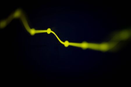abstract line stock market graph business on black background / yellow line and point analysis investment indicator of financial board display money conceptの写真素材