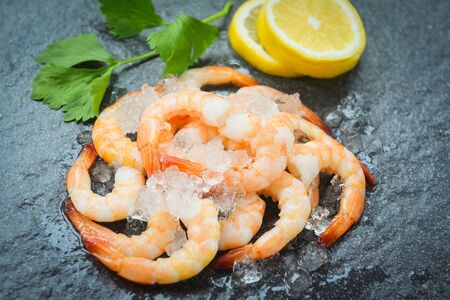 fresh shrimps served on plate / boiled peeled shrimp prawns cooked with ice background in the seafood restaurantの写真素材