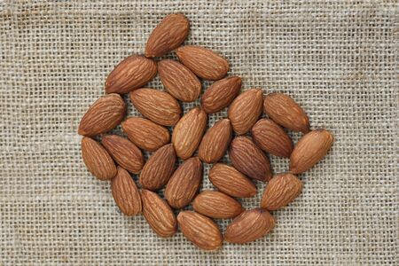 Close up almond nuts natural protein food and for snack / Almonds on sack background