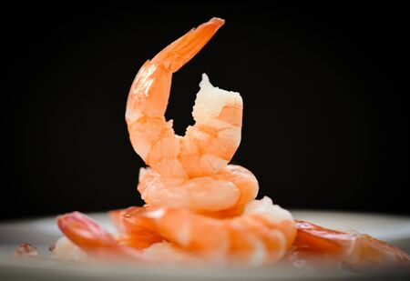 Decorate dining table food shrimps prawns boiled cooked seafood on dark black background / beautiful shrimpの写真素材