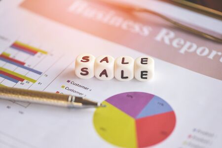 business report financial statistics documents with pen on infographics at office table closeup / Sales report marketing conceptの写真素材