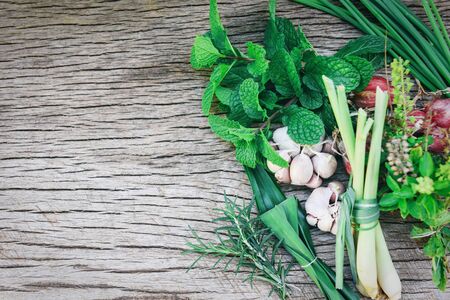 Natural fresh herbs and spice on rustic wood background in the kitchen for ingredient food / kitchen herb garden concept , top view copy spaceの写真素材