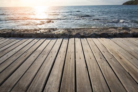 Terrace view sea with empty wooden table top on the beach landscape nature with sunset or sunrise /...