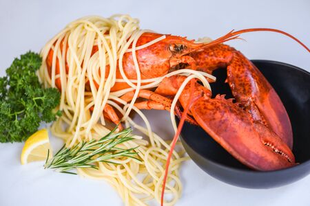 Spaghetti seafood lobster food on a white plate with herb spices lemon rosemary served table in the restaurant gourmet food healthy boiled lobster cooked salad spaghetti shrimp on bowl の写真素材