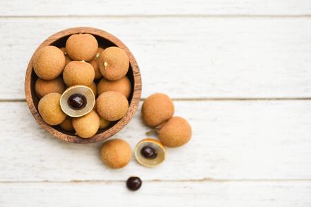 Dimocarpus longan exotic fruits on wooden bowl background / Fresh Longan  tropical fruit in Thailand