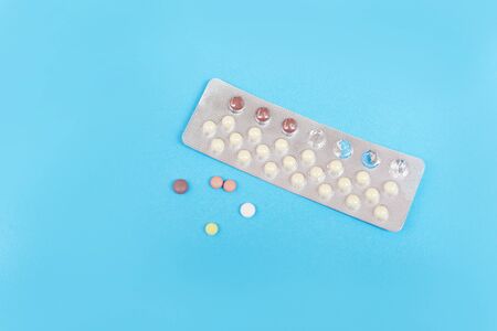 Contraception pills on blue background / Birth control contraceptive means prevent pregnancy