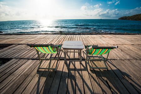 Terrace view of sea waves and coast landscape seascape with bench chair beach on wooden bridge...