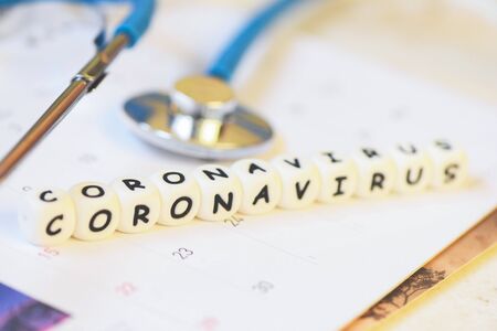 Coronavirus words and stethoscope on calendar / COVID-19 coronavirus spread influenza medical crisis...