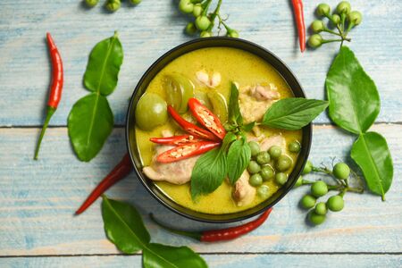 Green curry chicken cuisine asian food on the table / Thai food green curry on soup bowl with ingredient herb vegetable backgroundの写真素材