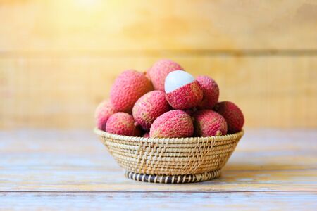 Lychee slice peeled on wooden background / Fresh lychee harvest in basket from tree tropical fruit summer in Thailand の写真素材