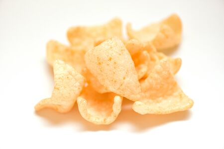 prawn crackers chips isolated on white background / homemade crunchy prawn crackers or shrimp crisp rice traditional snackの写真素材