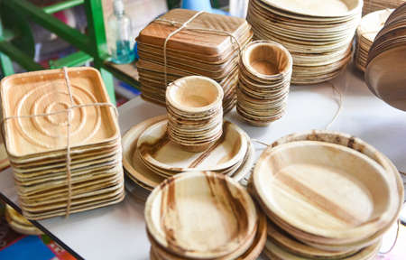 Eco friendly disposable tableware from palm leaf or betel nut , zero waste environment concept / Natural eco-friendly food packaging disposable utensils with dish plate bowl cupの写真素材