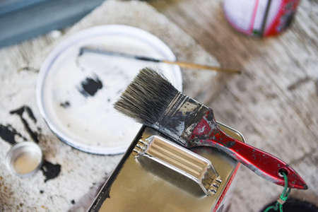 old paint brush on paint can Ready to be disposed / dirty paint brushes