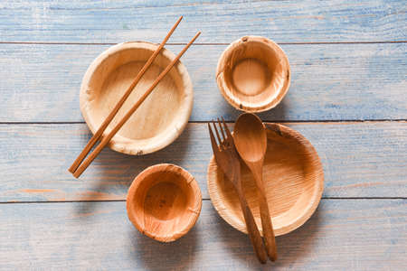 Natural eco-friendly food packaging disposable utensils with dish plate bowl cup and wooden fork...