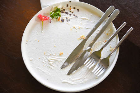 dirty dishes with cake and knife fork / dirty plate and empty dishes , top view