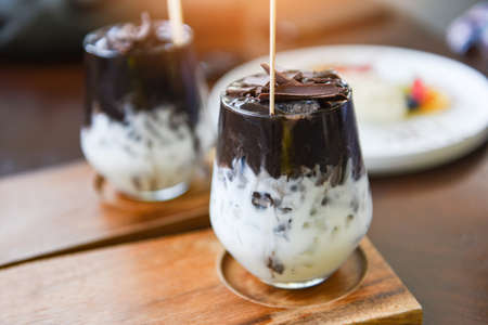 cocoa drink and chocolate / tasty milk shake with ice cocoa in glass on wood backgroundの写真素材