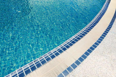 swimming pool tiles / most beautiful cool water in swimming pool background with blue tileの写真素材