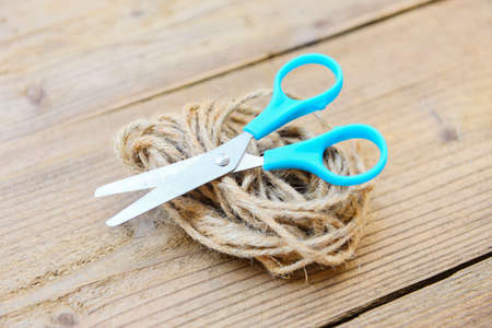 Rope and scissors on wooden background / Hemp rope or Natural ropeの写真素材