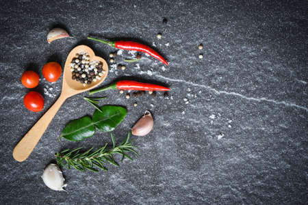 Herbs and spices with pepper chili, tomato and garlic for cooking, top view.の写真素材