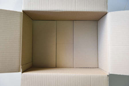 Open cardboard box on floor background, High angle view of an empty cardboard box or Parcel boxの写真素材