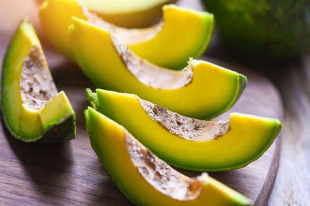 Avocado fruit and slice avocado on wooden background, Fruits healthy food concept.の写真素材