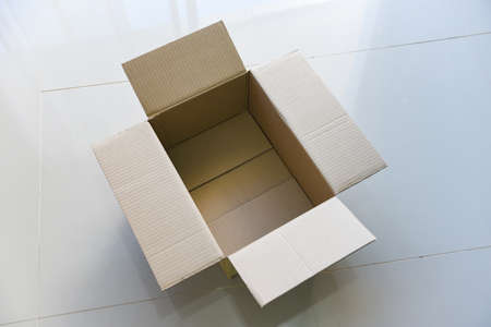 Open cardboard box on floor background, High angle view of an empty cardboard box or Parcel box