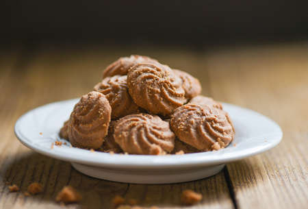cookies chocolate on white plate and wooden background, mini cookies biscuits