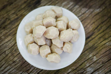 Meat ball on white plate on wooden background, meat ball with pork and ingredient for cooked asian thai foodの写真素材