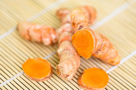 turmeric on wooden , fresh turmeric root for nature medicine herb and cooked ingredient food