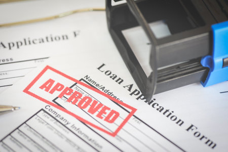 Loan application form with Rubber stamping that says Loan Approved, Financial loan money contract agreement company credit or person - loan approvalの写真素材