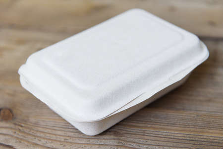 Service food order online delivery food box, delivery in take away boxes, disposable eco friendly packaging containers on wooden table at homeの写真素材