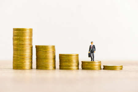 Golden coins stack on wooden table background, stack of coins financial growth ladder and business...